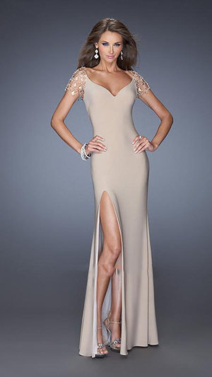 Glamorous fitted jersey gown with a side slit in the skirt. The cap sleeves are made of La Femme's original crystal chandelier design. Back is open and covered with a sheer net. Side zipper closure.