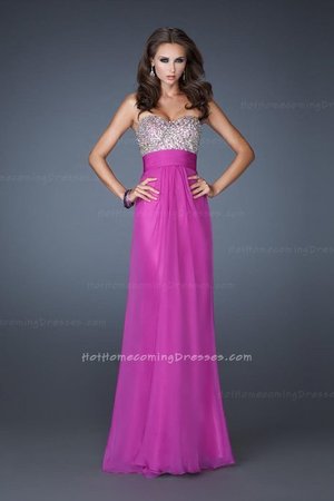 You are sure to dazzle in this flowing chiffon gown. This dress features a Strapless, Slight Sweetheart Neckline. The Bodice of the Dress features Stunning Iridescent Beadwork. The Back of the Dress features Beautiful Criss Cross Straps which are Encrusted with Dazzling Beadwork. This dress is Flowy which gives you the comfort you need for dancing the night away. Perfect as a Prom Dress, Wedding Guest Dress, Prom Dress, or a Special Occasion Dress.Size: Standard Size or Custom Made SizeClosure: ZipperDetails: Criss-Cross Sequined Back, A-Line skirtFabric: Chiffon Length: Floor LengthNeckline: Strapless Sweetheart Waistline: NaturalColor: MagentaTag: Magenta, Strapless, Long, Sequined Bodice, Open Back, Prom Dress