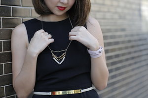 Adding a simple necklace to your black outfit to lift up the look.