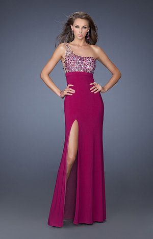 We are in love with this La Femme 19808 gown! This sexy dress has a fabulous, one-shoulder strap, beadwork up top, and a flawless cut out in the back. You will love wearing this dress to prom, your next formal event, or black tie affair! This dress is perfect as a Homecoming Dress, Wedding Guest Dress, Prom Dress, or a Special Occasion Dress. Size: Standard Size or Custom Made SizeClosure: Side ZipperDetails: Asymmetrical Bodice, Side Slit, Sheer BackFabric: JerseyLength: LongNeckline: One ShoulderWaistline: NaturalColor: MagentaTag: Magenta, Long, Slit, One Shoulder, Prom Dresses, La Femme 19808