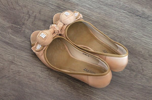 Love the rosette that liven up the classic nude peep toe