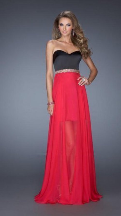 Strapless satin dress with a sweetheart neckline. The skirt is short with an attached long chiffon overlay. The waist is highlighted with an iridescent stone encrusted belt. Back zipper closure.