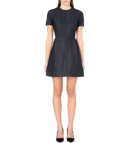 A Denim Dress#Victoria Beckham paneled denim dress
The hottest denim silhouette for the new year is...drumroll, please...the dress! Traditionally boxier in style, a denim dress works with sky-high heels for a night out or with moto boots for a Saturday morning