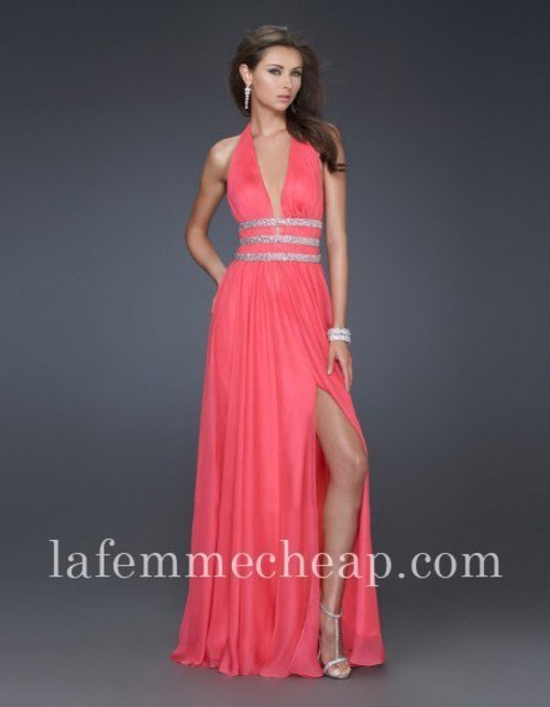 This glamorous La Femme 16123 evening gown is a truly breathtaking ensemble. This gown features an alluring ruched halter bodice with a deep plunging V-neckline that will surely turn heads at any event. The fitted bodice hugs to your waist with sparkling crystal beaded bands for an utterly flattering fit, while it accentuates the sultry low-cut back design. Its floor length flowing A-line skirt smoothly drapes from the natural waist with a sexy upper-thigh slit to complete the look. Size: Standard Size or Custom Made SizeClosure: Side ZipperDetails: Bands of Silver, Side SlitFabric: ChiffonLength: Floor LengthNeckline: Deep V, Wide Halter Waist: NaturalColor: CoralTag: Coral, Halter, Long, Evening Dresses, La Femme 16123