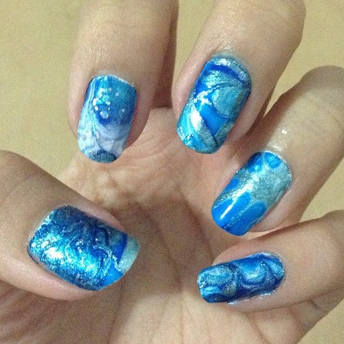 This is my first marble nail art. I made this because i saw it on youtube and it looks cute and elegant. I loooooooove the marble effect on my nail. Each nail have different pattern.