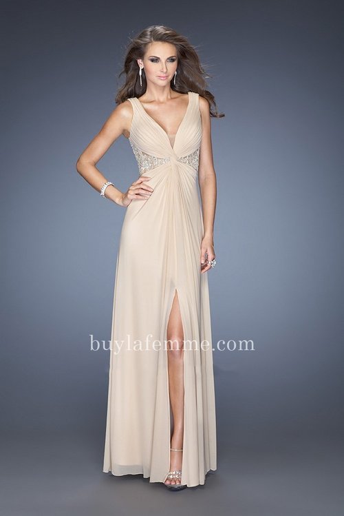 Attractive V-neck La Femme 20142 jersey gown with a sheer net inset at the bottom of the neckline. The bodice is gathered into a twisted ruched knot. Side cut outs and back are covered in jeweled lace. This dress is perfect as a Homecoming Dress, Wedding Guest Dress, Prom Dress, or a Special Occasion Dress. Size: Standard Size or Custom Made SizeClosure: Back ZipperDetails: Ruched,Front Slit, Jeweled Lace BackFabric: Jersey, NetLength: LongNeckline: V-neckWaistline: NaturalColor: NudeTag: Nude, Long, V-neck, Slit, Prom Dresses, La Femme 20142